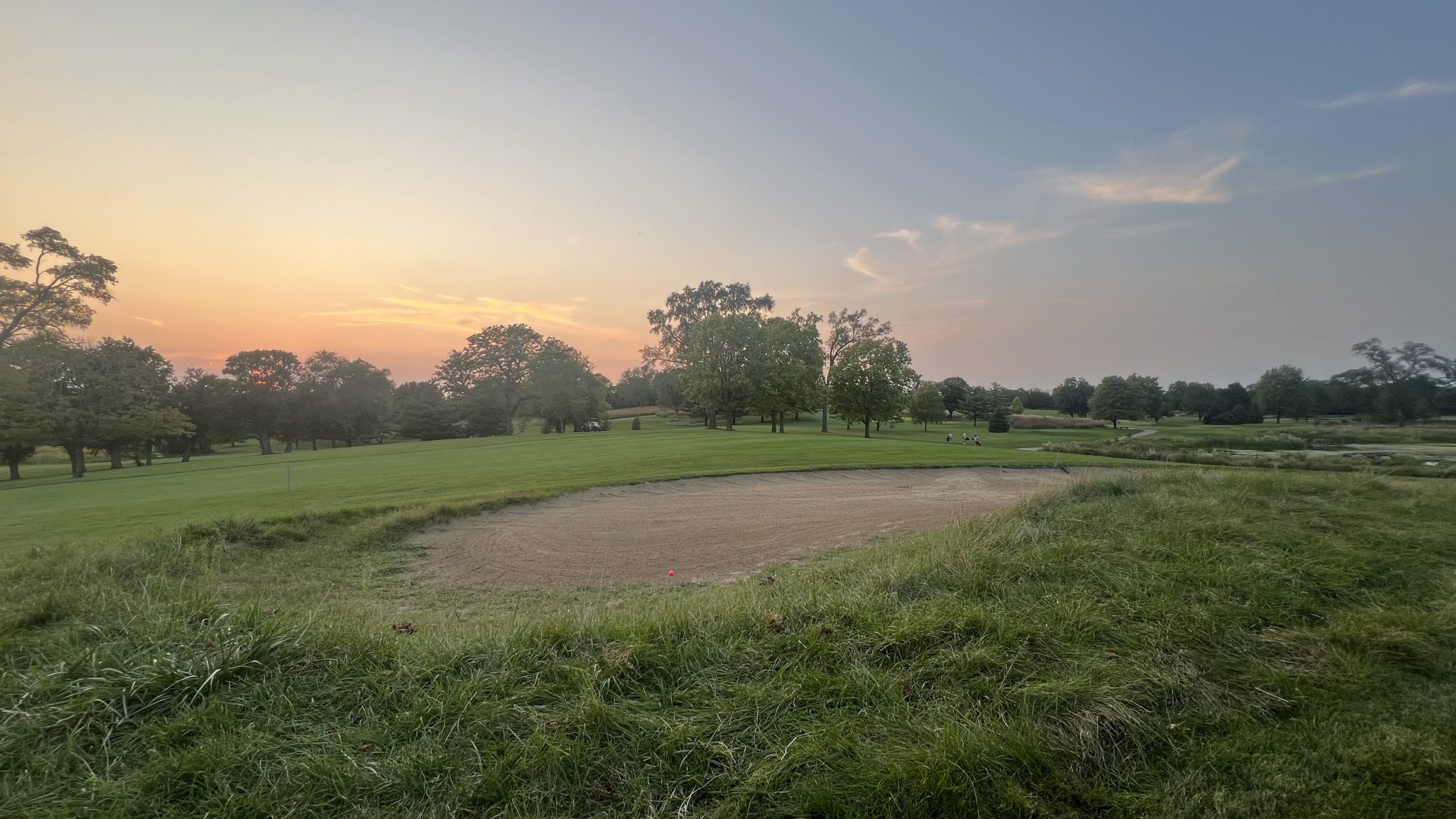 Golf course sunset timing scene