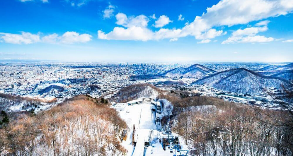 눈 덮인 산과 숲이 펼쳐진 삿포로 근교 겨울 풍경